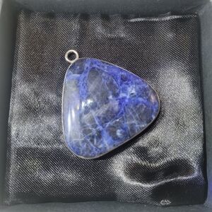Handmade Sodalite pendant with a sterling silver bail and bezel setting.